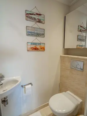 a bathroom with a white toilet and a sink at Cannes Croisette Superbe 3P front de mer in Cannes