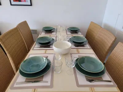 a table with green plates and glasses on it at T2 + CABINE VILLA FRANCIA in Cannes
