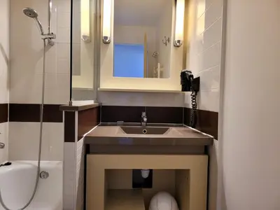 a bathroom with a sink and a mirror and a toilet at T2 + CABINE VILLA FRANCIA in Cannes