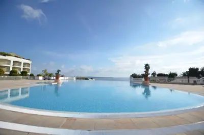 a large swimming pool with the ocean in the background at T2 + CABINE VILLA FRANCIA in Cannes