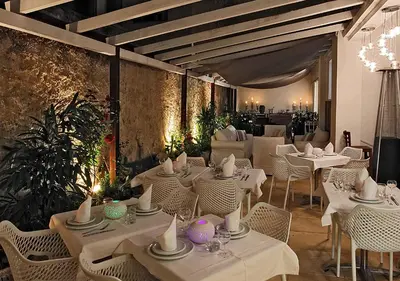 a dining room with white tables and chairs at HOTEL PALM BEACH in Cannes