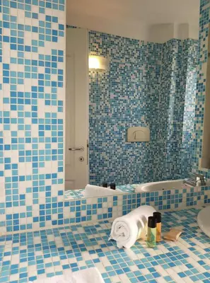 a blue tiled bathroom with a sink and a toilet at C060-Bel Appartement avec Vue Mer - Picaud in Cannes