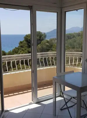 a room with a table and a view of the ocean at C060-Bel Appartement avec Vue Mer - Picaud in Cannes