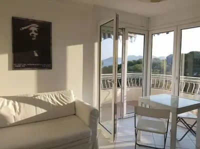 a living room with a couch and a table at C060-Bel Appartement avec Vue Mer - Picaud in Cannes