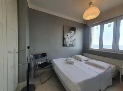a bedroom with a large bed and a window at C060-Bel Appartement avec Vue Mer - Picaud in Cannes