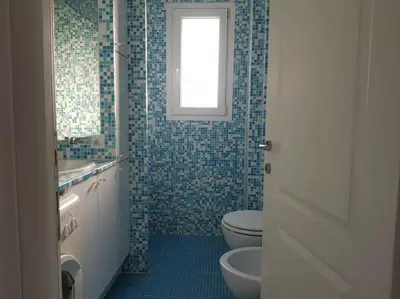 a bathroom with a toilet and a sink and a window at C060-Bel Appartement avec Vue Mer - Picaud in Cannes