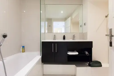 a bathroom with a tub and a sink and a mirror at Modern & cozy 150m from the Croisette in Cannes