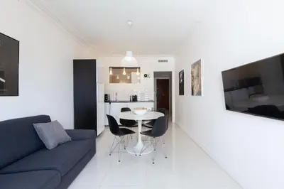 a living room with a couch and a table at Modern & cozy 150m from the Croisette in Cannes