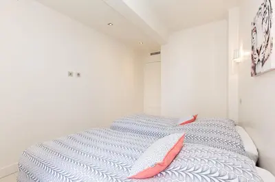 a bedroom with a bed with two pillows on it at Modern & cozy 150m from the Croisette in Cannes