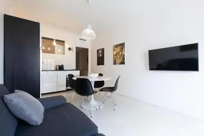 a living room with a couch and a table with chairs at Modern & cozy 150m from the Croisette in Cannes