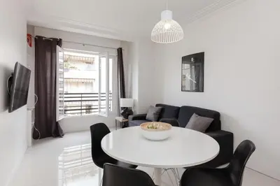 a living room with a white table and chairs at Modern & cozy 150m from the Croisette in Cannes