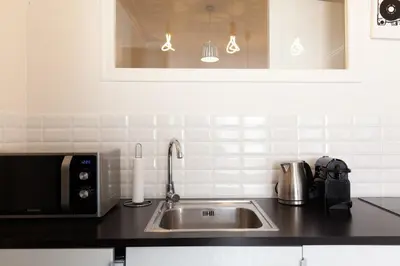 a kitchen with a sink and a microwave at Modern & cozy 150m from the Croisette in Cannes