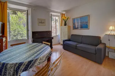 a living room with a couch and a table at IMMOGROOM - 5 min from beaches - Suquet - AC in Cannes