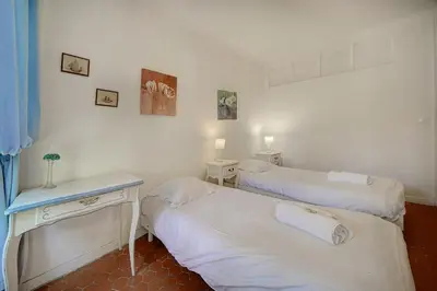 a room with two beds and a table with two towels at IMMOGROOM - 5 min from beaches - Suquet - AC in Cannes
