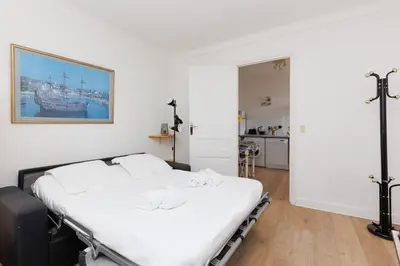a white bed in a room with at IMMOGROOM - 5 min from beaches - Suquet - AC in Cannes