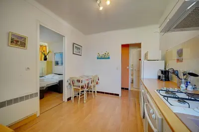 a kitchen with a counter and a table in a room at IMMOGROOM - 5 min from beaches - Suquet - AC in Cannes
