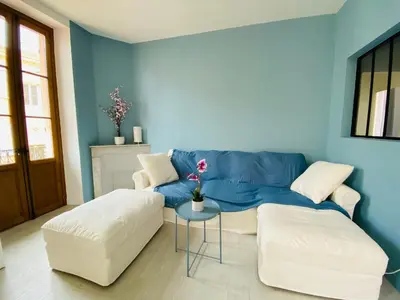 a blue living room with a couch and a table at Grand appartement proche plages & centre ville in Cannes