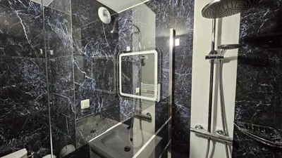 a bathroom with a shower with a mirror and a sink at Magnifique T2 Climatisation - Grande Terrasse, Piscine et apercu Mer in Cannes
