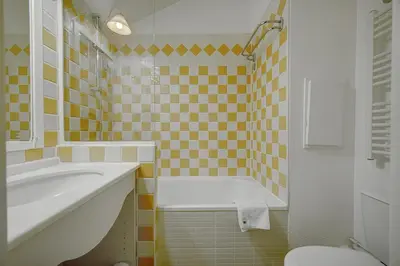 a bathroom with a tub and a sink and a toilet at IMMOGROOM - 2BR - sea view - Swimming pool - Terrace - Parking - AC - Wifi in Cannes