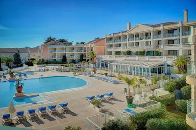 a resort with a pool and chairs and a hotel at IMMOGROOM - 2BR - sea view - Swimming pool - Terrace - Parking - AC - Wifi in Cannes