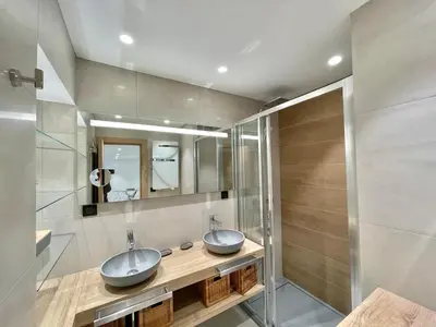 a bathroom with two sinks and a mirror at Branly 4, by Welcome to Cannes in Cannes