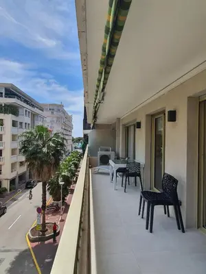 a balcony with chairs and a table on a building at Branly 4, by Welcome to Cannes in Cannes
