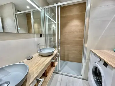 a bathroom with a sink and a washing machine at Branly 4, by Welcome to Cannes in Cannes