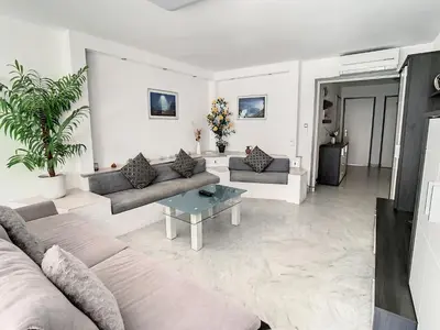a living room with two couches and a table at Appartements de Standing Cannes Centre in Cannes