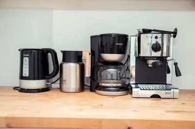 three coffins and a coffee maker on a wooden counter at AnaZa Appartement in Cannes