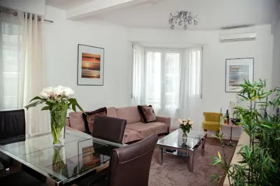 a living room with a couch and a glass table at AnaZa Appartement in Cannes