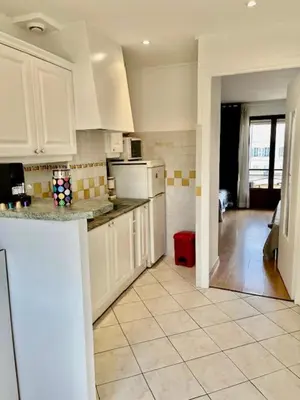a kitchen with white cabinets and a counter top at Idéal congrès Studio 33m2 à 4 minutes du Palais in Cannes