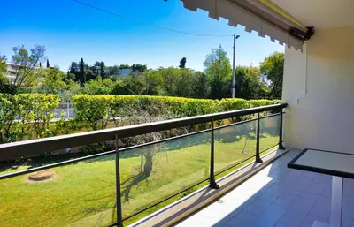 a balcony with a view of a yard at Ref BEAUSITE - Palmes d'Or Properties in Cannes