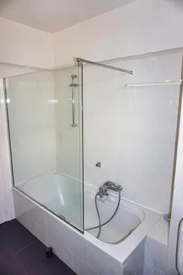 a bath tub with a glass shower stall in a bathroom at Ref BEAUSITE - Palmes d'Or Properties in Cannes