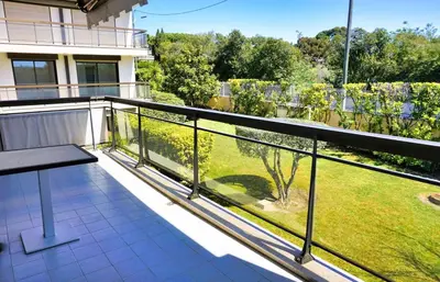 a balcony with a view of a yard at Ref BEAUSITE - Palmes d'Or Properties in Cannes