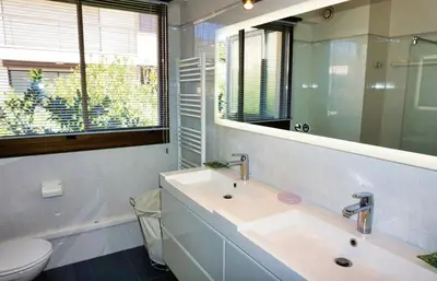 a bathroom with a sink and a mirror and a toilet at Ref BEAUSITE - Palmes d'Or Properties in Cannes