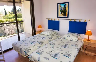 a bedroom with a bed and a large window at Ref BEAUSITE - Palmes d'Or Properties in Cannes