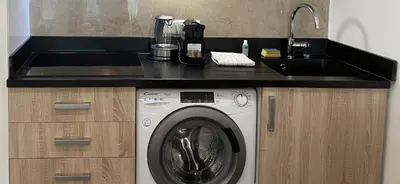 a kitchen with a sink and a washing machine at Cannes Centre, T2 moderne rénové, balcon clim&Wifi in Cannes