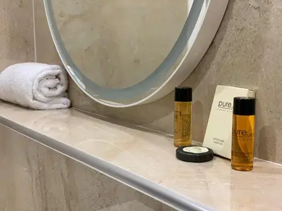 a bathroom counter with a mirror and a towel at Cannes Centre, T2 moderne rénové, balcon clim&Wifi in Cannes