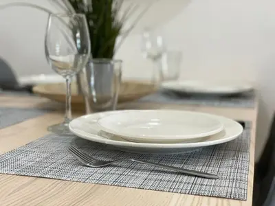 a plate and a fork on a table with glasses at Cannes Centre, T2 moderne rénové, balcon clim&Wifi in Cannes