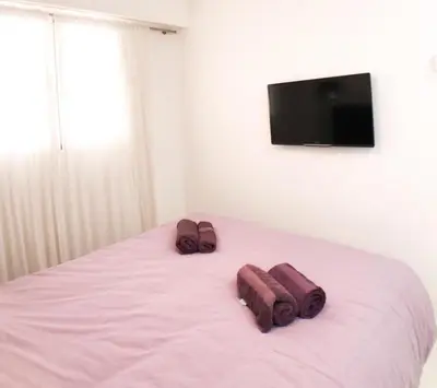 a bed with two brown towels on top of it at 2 pièces Luxueux en face du Martinez et Croisette in Cannes