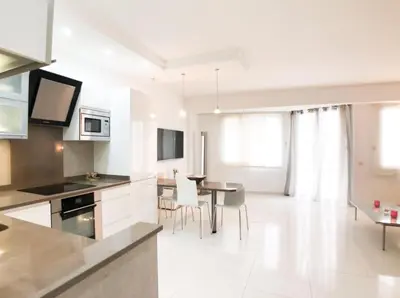 a kitchen and dining room with a table and chairs at 2 pièces Luxueux en face du Martinez et Croisette in Cannes