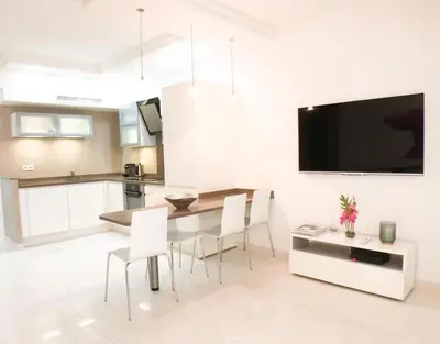a kitchen and dining room with a table and chairs at 2 pièces Luxueux en face du Martinez et Croisette in Cannes