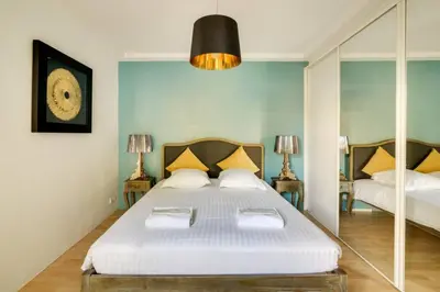 a bedroom with a large white bed and a mirror at C059-Splendid apartment with air conditioned - Cannes in Cannes