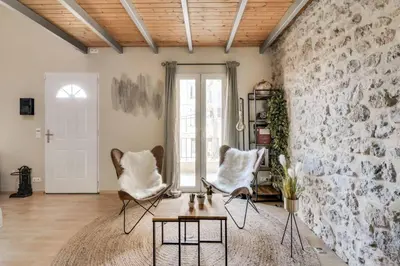 a living room with two chairs and a stone wall at C059-Splendid apartment with air conditioned - Cannes in Cannes