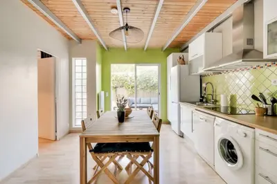 a kitchen with a wooden table and a kitchen with green walls at C059-Splendid apartment with air conditioned - Cannes in Cannes