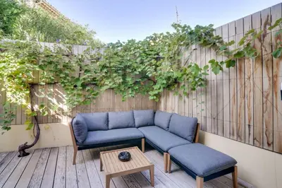 a patio with a couch and a table and vines at C059-Splendid apartment with air conditioned - Cannes in Cannes