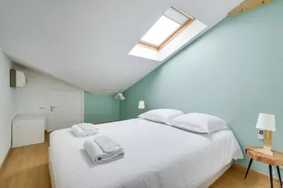 a bedroom with a white bed and a skylight at C059-Splendid apartment with air conditioned - Cannes in Cannes