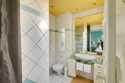 a bathroom with a sink and a toilet and a mirror at C059-Splendid apartment with air conditioned - Cannes in Cannes