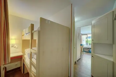 a small room with a bed and a closet at IMMOGROOM - 2 Rooms - Renovated - Pool - AC - Parking - Garden in Cannes