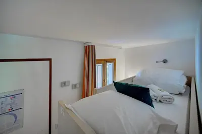 a bedroom with two white beds and a window at IMMOGROOM - 2 Rooms - Renovated - Pool - AC - Parking - Garden in Cannes